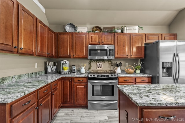 14908 E 88th St, Owasso, OK 74055 - kitchen with appliances with stainless steel finishes, light stone counters, light wood-style floors, and brown cabinetry