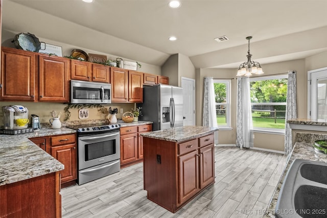 14908 E 88th St, Owasso, OK 74055 - kitchen featuring stainless steel appliances, wood tiled floors, hanging light fixtures, recessed lighting, and lofted ceiling