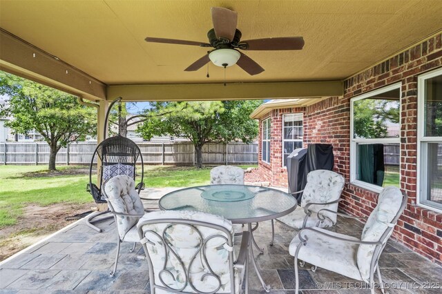 14908 E 88th St, Owasso, OK 74055 - fenced backyard featuring a patio, a ceiling fan, outdoor dining space, and a grill