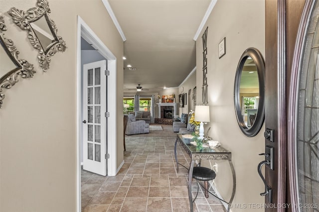 14908 E 88th St, Owasso, OK 74055 - foyer featuring stone finish floors, ornamental molding, a brick fireplace, and a ceiling fan