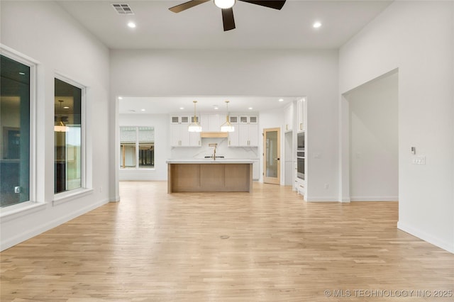 2985 E 146th St S, Bixby, OK 74008 - unfurnished living room featuring light wood finished floors, a ceiling fan, and recessed lighting