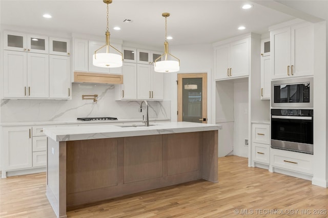 2985 E 146th St S, Bixby, OK 74008 - kitchen with stainless steel appliances, light wood finished floors, white cabinets, decorative backsplash, and recessed lighting