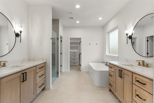 2985 E 146th St S, Bixby, OK 74008 - bathroom with a shower stall, two vanities, a spacious closet, a freestanding bath, and recessed lighting