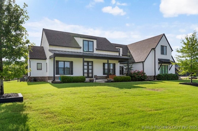 19021 E Chokeberry St, Owasso, OK 74055 - view of front of home featuring a standing seam roof, roof with shingles, a front lawn, covered porch, and a metal roof