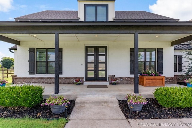 19021 E Chokeberry St, Owasso, OK 74055 - view of exterior entry with covered porch, brick siding, and a shingled roof