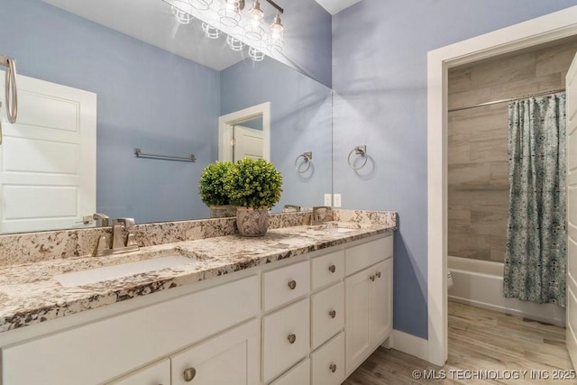 19021 E Chokeberry St, Owasso, OK 74055 - bathroom with double vanity, wood finished floors, and shower / bath combo