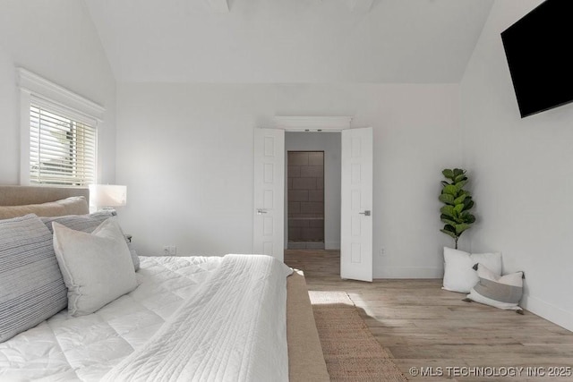 19021 E Chokeberry St, Owasso, OK 74055 - bedroom featuring lofted ceiling and wood finished floors