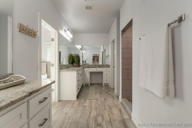 19021 E Chokeberry St, Owasso, OK 74055 - bathroom with wood finished floors, vanity, and tiled shower