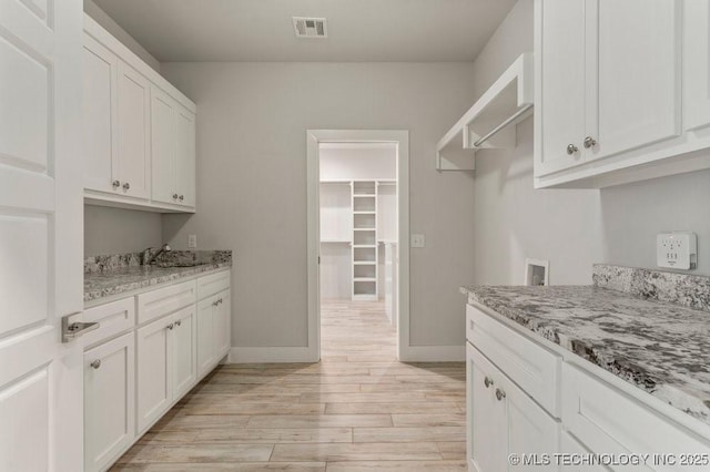 19021 E Chokeberry St, Owasso, OK 74055 - laundry area with cabinet space, light wood finished floors, and washer hookup