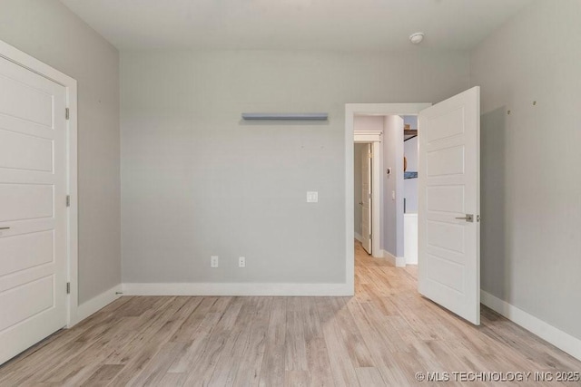 19021 E Chokeberry St, Owasso, OK 74055 - empty room with light wood-style floors and a smoke detector