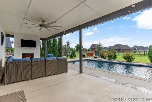 19021 E Chokeberry St, Owasso, OK 74055 - view of patio with an outdoor living space with a fireplace, a ceiling fan, and an outdoor pool