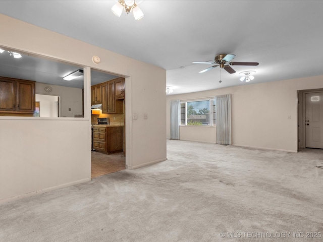 123 S Madison Blvd, Bartlesville, OK 74006 - unfurnished living room featuring a ceiling fan and light colored carpet