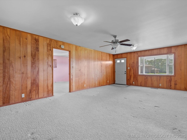 123 S Madison Blvd, Bartlesville, OK 74006 - unfurnished room featuring carpet, wooden walls, and ceiling fan