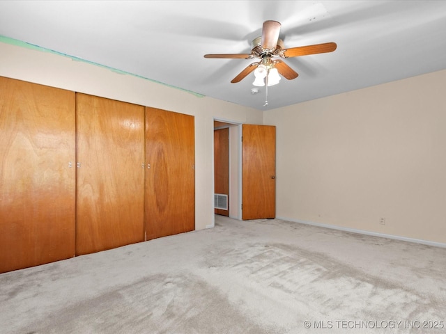 123 S Madison Blvd, Bartlesville, OK 74006 - unfurnished bedroom with a closet, carpet, and ceiling fan