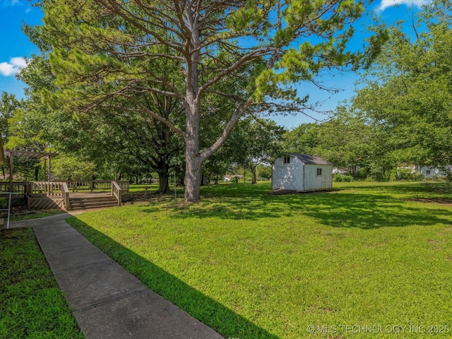 123 S Madison Blvd, Bartlesville, OK 74006 - view of green lawn with a storage unit and a wooden deck