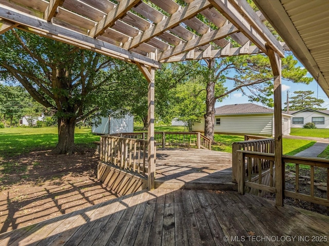 123 S Madison Blvd, Bartlesville, OK 74006 - deck featuring a pergola, a lawn, and an outbuilding