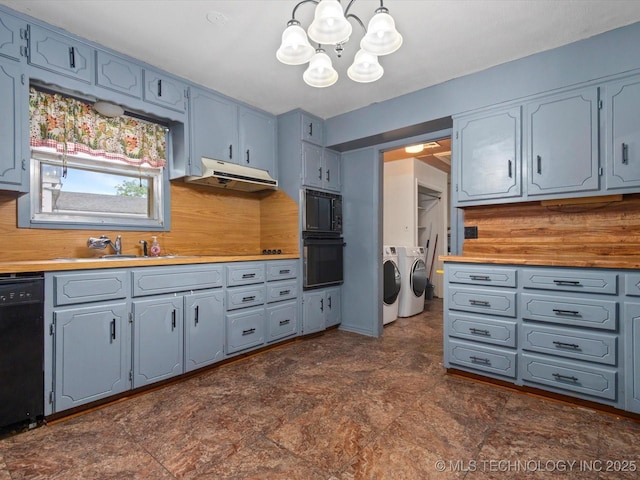 105 E Brahma Ave, Dewey, OK 74029 - kitchen with independent washer and dryer, black appliances, under cabinet range hood, a chandelier, and gray cabinetry