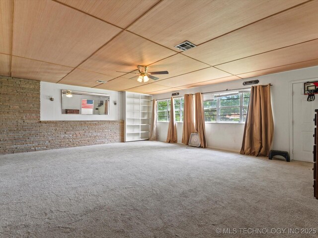 105 E Brahma Ave, Dewey, OK 74029 - unfurnished living room featuring wood ceiling, a ceiling fan, carpet, and brick wall