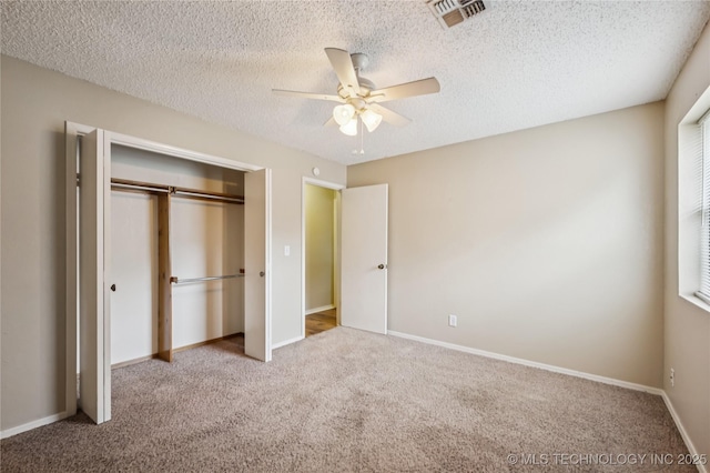 612 S 5th St, Eufaula, OK 74432 - unfurnished bedroom with carpet flooring, a closet, a textured ceiling, and ceiling fan