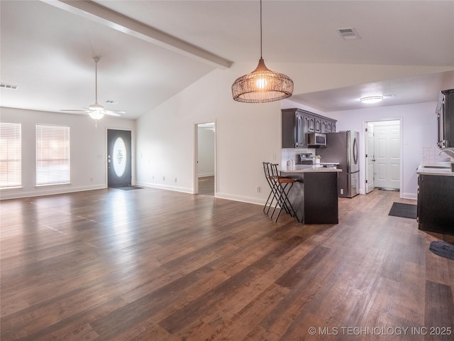 3404 N Birch, Mcalester, OK 74501 - kitchen with appliances with stainless steel finishes, light countertops, dark brown cabinets, a kitchen bar, and ceiling fan