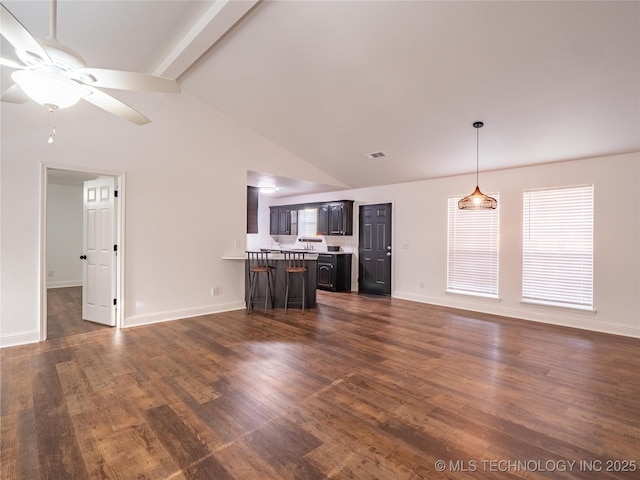 3404 N Birch, Mcalester, OK 74501 - unfurnished living room featuring ceiling fan, dark wood-type flooring, and high vaulted ceiling