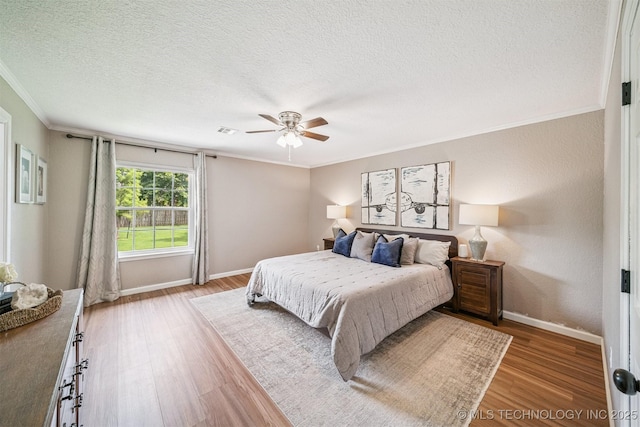 11017 E 98th St N, Owasso, OK 74055 - bedroom featuring ornamental molding, light wood-style flooring, a textured ceiling, and ceiling fan