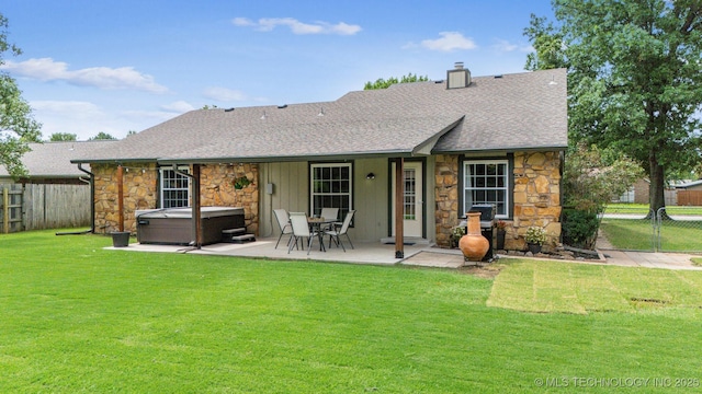 11017 E 98th St N, Owasso, OK 74055 - back of house featuring stone siding, a hot tub, roof with shingles, a patio, and a chimney