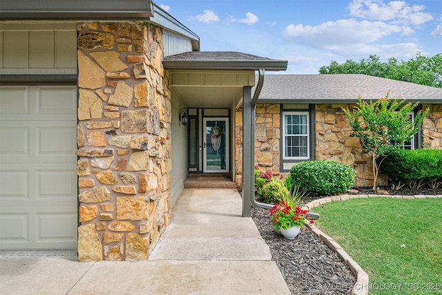 11017 E 98th St N, Owasso, OK 74055 - property entrance featuring stone siding, a shingled roof, a garage, and a lawn