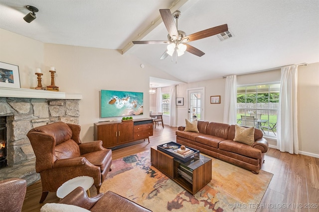 11017 E 98th St N, Owasso, OK 74055 - living area with light wood-style floors, ceiling fan, and a fireplace