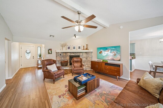 11017 E 98th St N, Owasso, OK 74055 - living room featuring light wood finished floors, ceiling fan, and a fireplace
