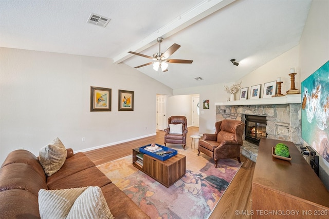 11017 E 98th St N, Owasso, OK 74055 - living area featuring wood finished floors, a stone fireplace, and ceiling fan