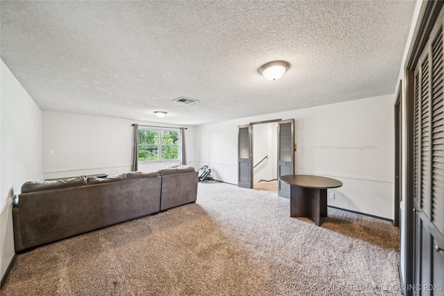6103 S 223rd E Ave, Broken Arrow, OK 74014 - carpeted living room featuring a textured ceiling and a wainscoted wall