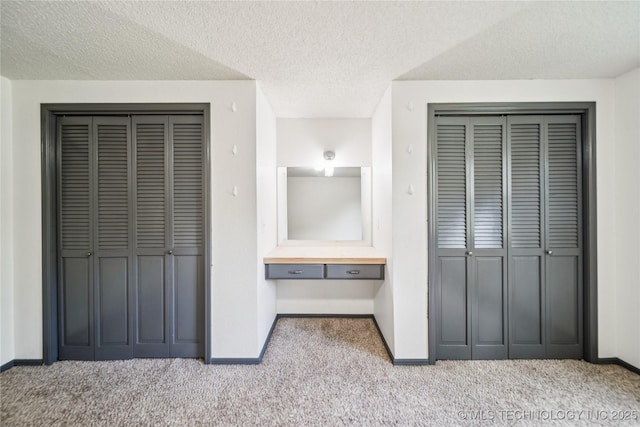6103 S 223rd E Ave, Broken Arrow, OK 74014 - unfurnished bedroom with carpet, multiple closets, and a textured ceiling