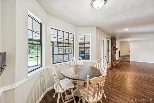6103 S 223rd E Ave, Broken Arrow, OK 74014 - dining area with wood finished floors, a fireplace, and recessed lighting