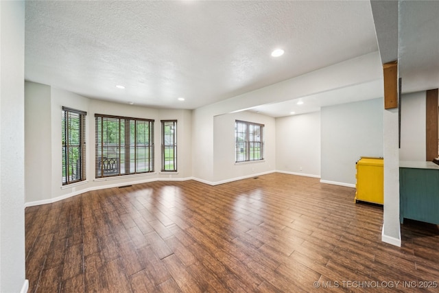 6103 S 223rd E Ave, Broken Arrow, OK 74014 - unfurnished living room featuring wood finished floors, a textured ceiling, and recessed lighting