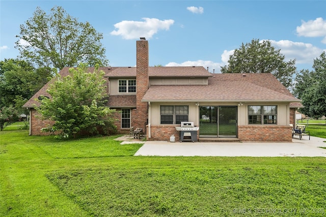 6103 S 223rd E Ave, Broken Arrow, OK 74014 - back of house featuring a patio area, a chimney, a yard, and brick siding