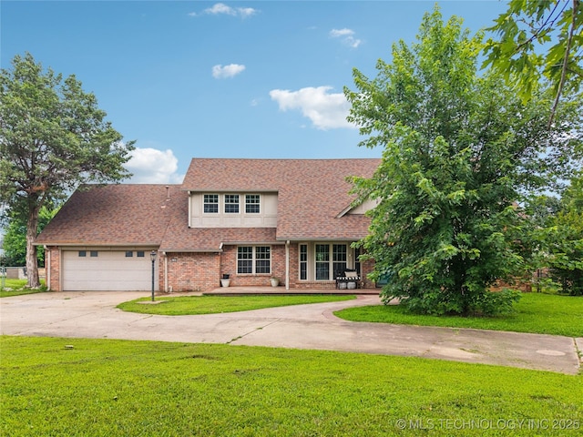 6103 S 223rd E Ave, Broken Arrow, OK 74014 - view of front of property featuring a front lawn, concrete driveway, a garage, brick siding, and a shingled roof