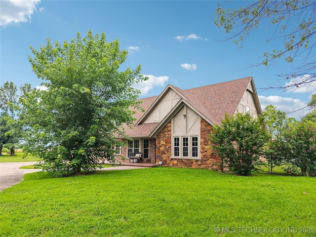 6103 S 223rd E Ave, Broken Arrow, OK 74014 - tudor house featuring stone siding, a front yard, and a shingled roof