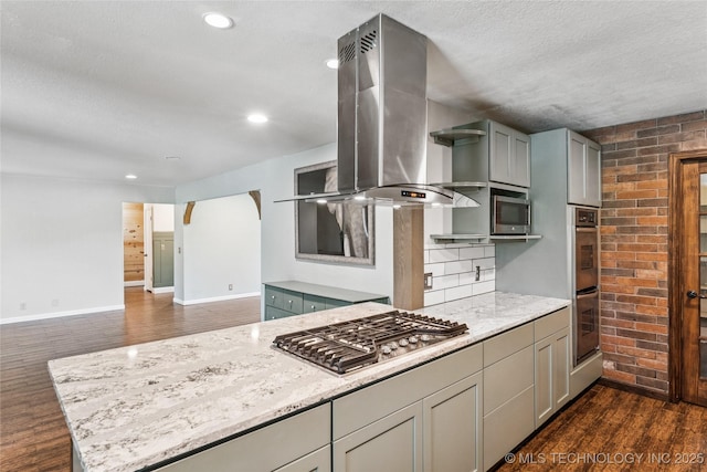 6103 S 223rd E Ave, Broken Arrow, OK 74014 - kitchen featuring ventilation hood, appliances with stainless steel finishes, dark wood-type flooring, light stone counters, and a textured ceiling