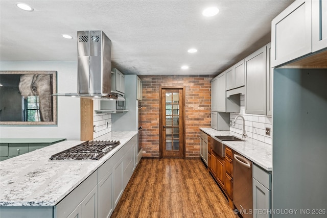 6103 S 223rd E Ave, Broken Arrow, OK 74014 - kitchen with island range hood, stainless steel appliances, brick wall, recessed lighting, and dark wood-style flooring