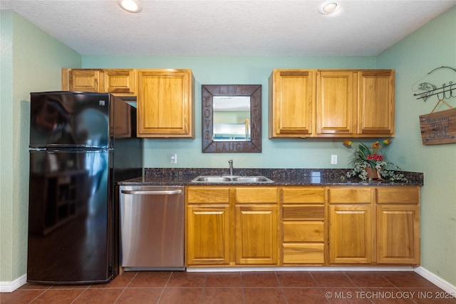 61112 E 310, Grove, OK 74344 - kitchen featuring stainless steel dishwasher, freestanding refrigerator, a textured ceiling, dark stone countertops, and dark tile patterned floors