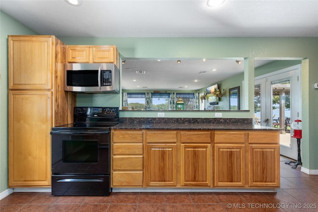 61112 E 310, Grove, OK 74344 - kitchen featuring stainless steel microwave, black electric range, dark tile patterned floors, dark stone counters, and recessed lighting