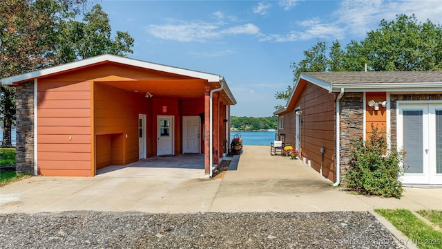 61112 E 310, Grove, OK 74344 - view of car parking featuring driveway, french doors, and a carport