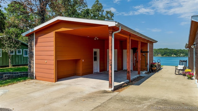 61112 E 310, Grove, OK 74344 - view of outbuilding with concrete driveway and a water view