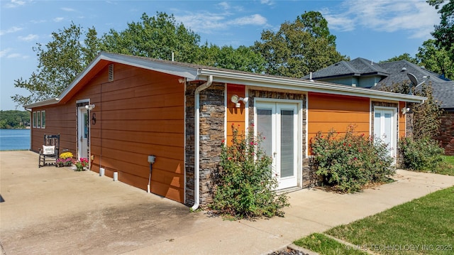 61112 E 310, Grove, OK 74344 - view of side of property featuring stone siding and a patio