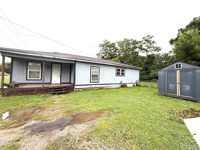 904 W Corporation St, Henryetta, OK 74437 - view of front of home featuring a porch, a shed, and a front lawn