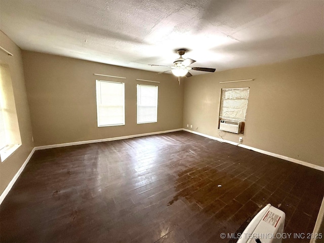 904 W Corporation St, Henryetta, OK 74437 - unfurnished room featuring cooling unit, a ceiling fan, and dark wood-style floors