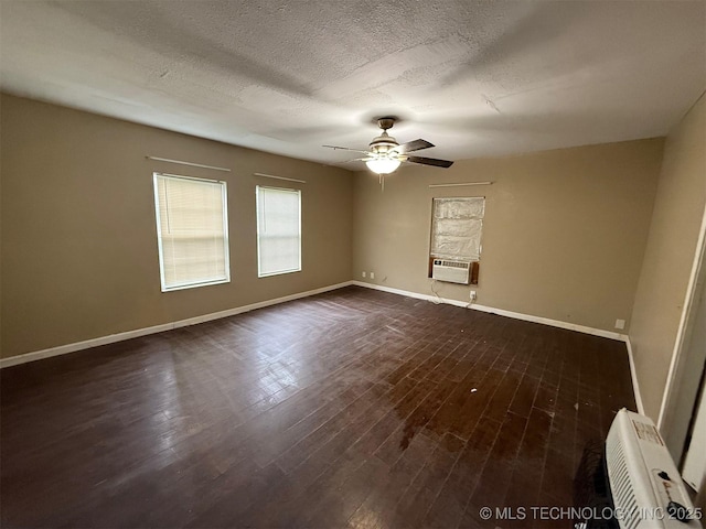 904 W Corporation St, Henryetta, OK 74437 - empty room featuring a ceiling fan, cooling unit, dark wood finished floors, and a textured ceiling