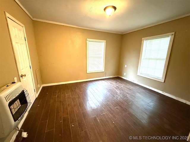 904 W Corporation St, Henryetta, OK 74437 - spare room featuring heating unit, ornamental molding, and dark wood finished floors