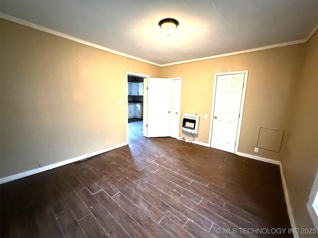 904 W Corporation St, Henryetta, OK 74437 - unfurnished living room featuring heating unit, dark wood-type flooring, and crown molding